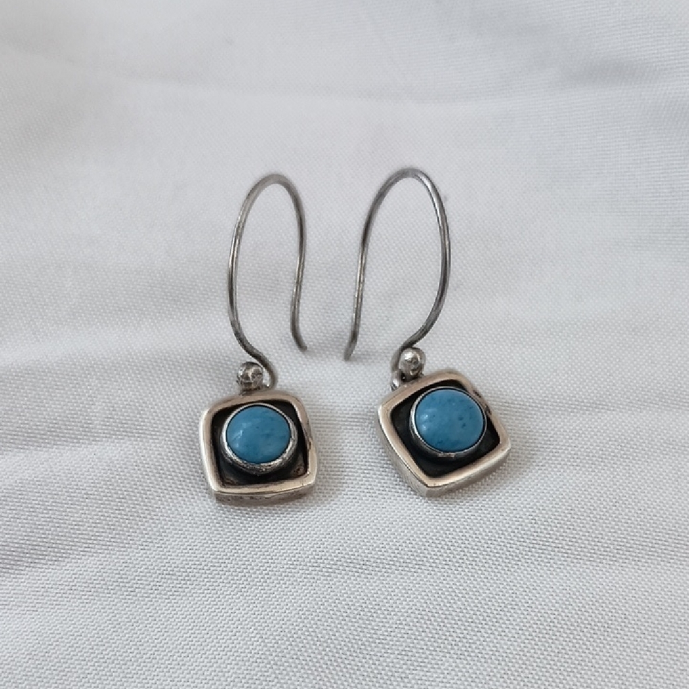 Small dangle Sterling Silver earrings featuring a blue larimar stone
